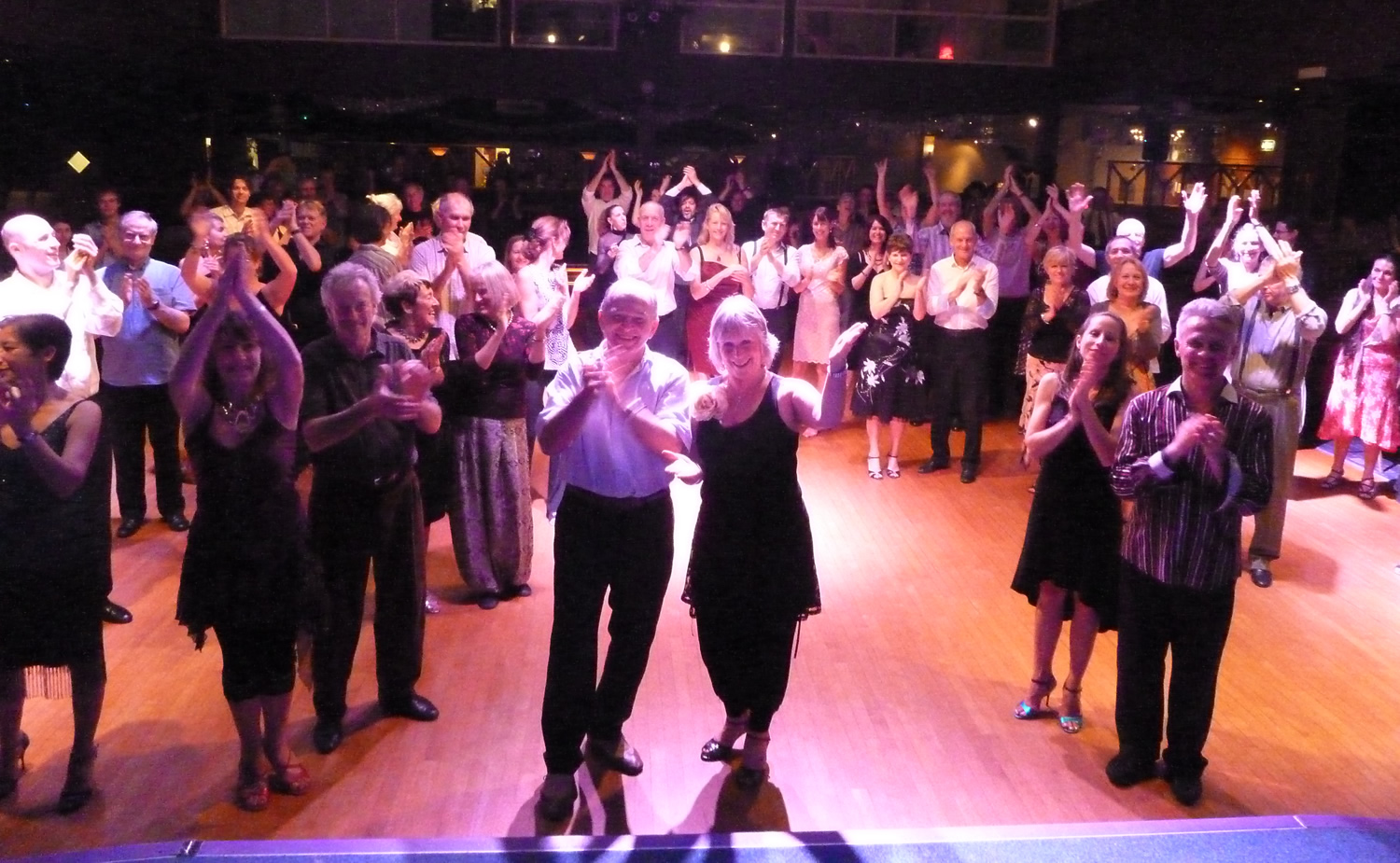 a happy crowd of dancers congratulating the DJs